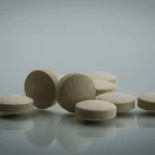 Macro shot detail of zinc amino acid chelate tablets pills on white background. Dietary supplement product for help sperm swim well. Vitamins, minerals and supplements for treatment male infertility.